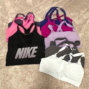 Lot of sports bras. 8 under armour. 1 Nike. Some with padding. Some without.